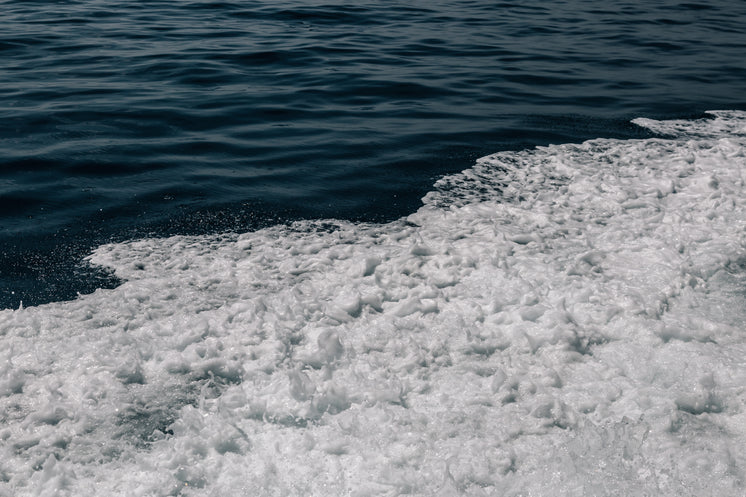Foamy Water Crashing To Shore