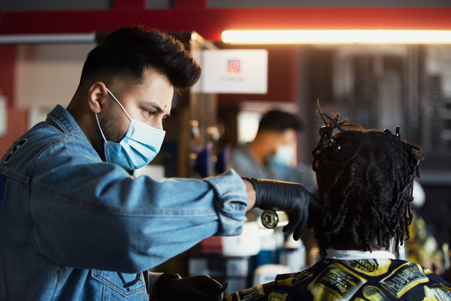 Focused barber cuts hair