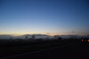 foggy hillside by highway at sundown
