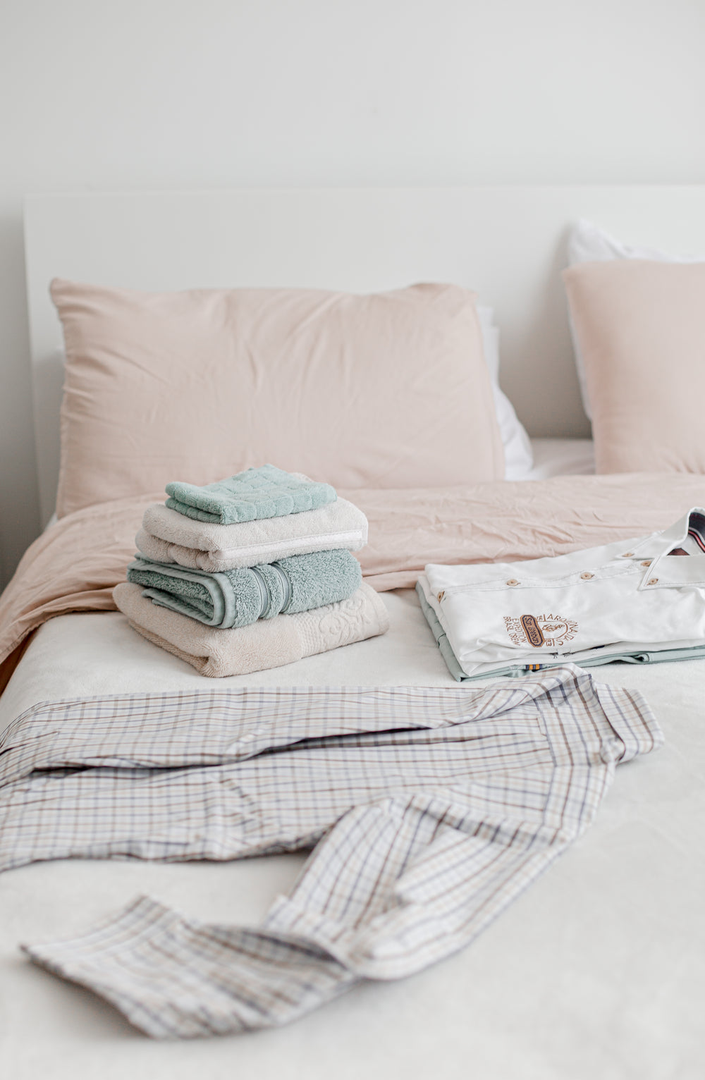 folding laundry on the bed