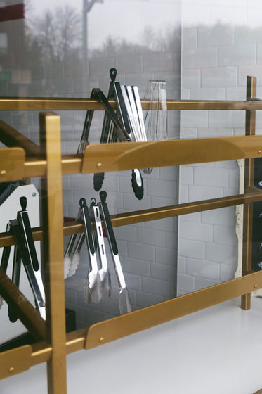 food tongs on a gold rack