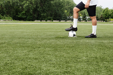 football player rests foot on ball