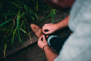 footwear close up man tying shoelace