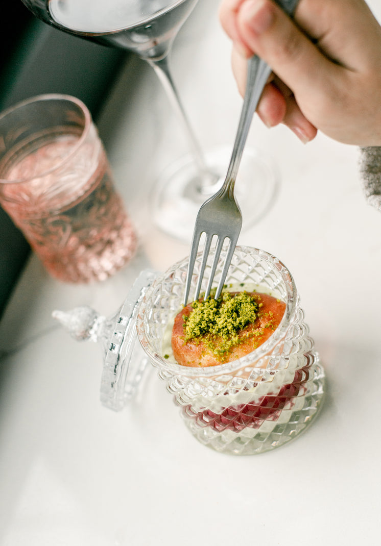 Fork Dips Into A Dessert In A Crystal Container