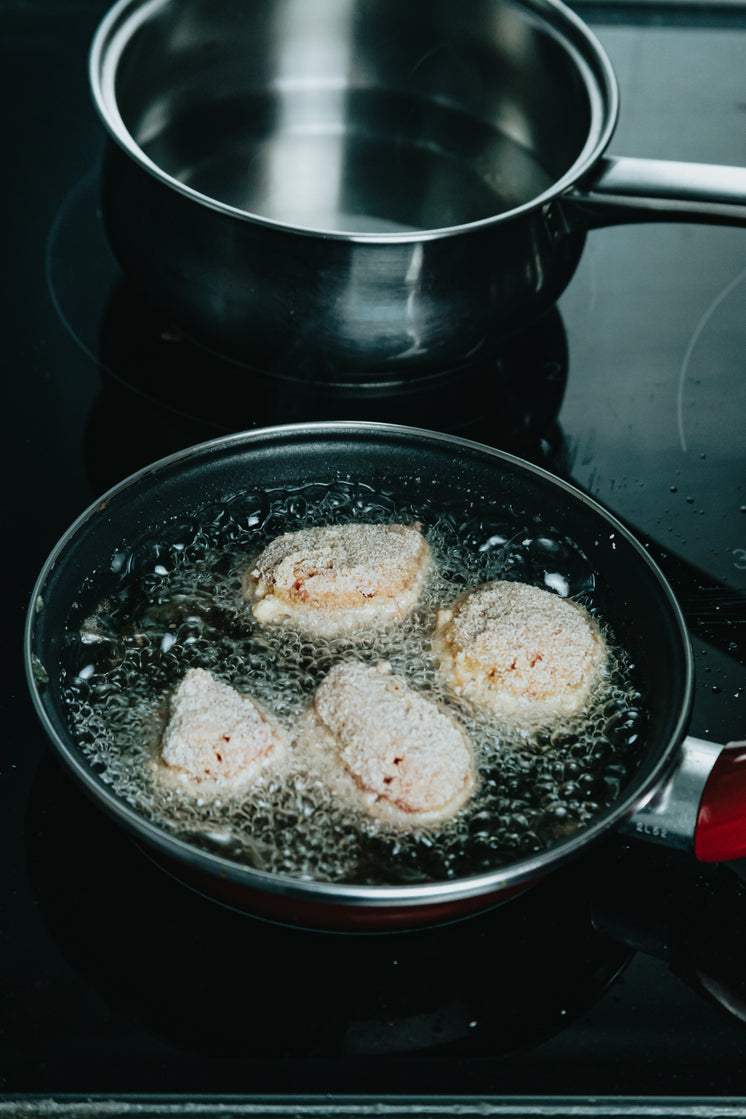 four-breaded-balls-are-being-fried-in-oi