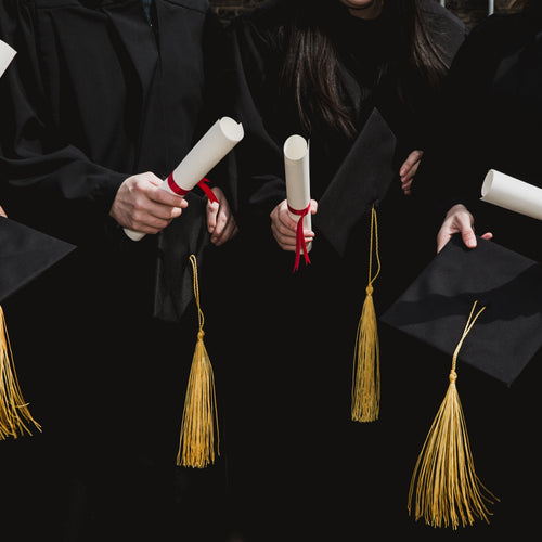 Four Grad Students Caps And Diplomas