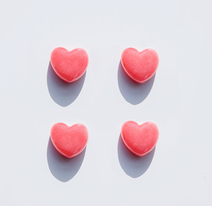 four hearts lay spaced out on a white background