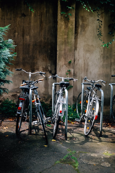 four parked shiny silver bikes