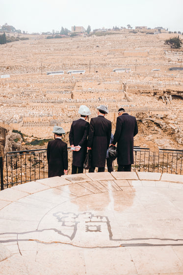 four people look out at fields of stone