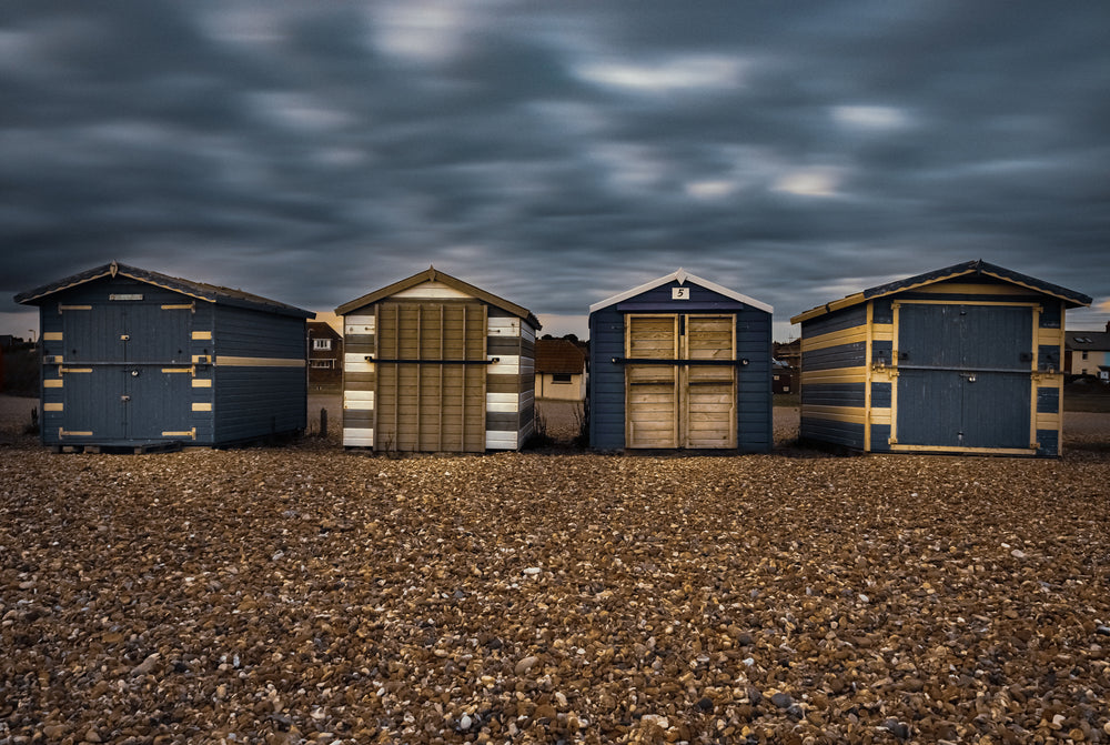 four small square buildings lined in a row