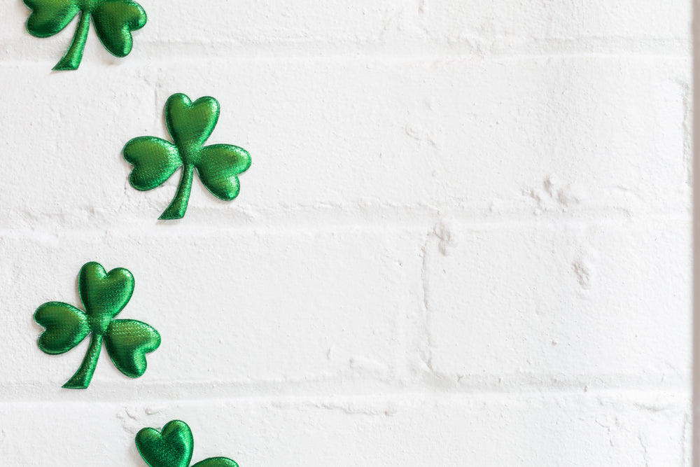 four three leaf clovers on brick wall