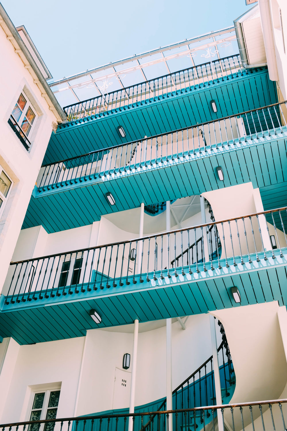 four tiers of wooden walkways in an apartment courtyard