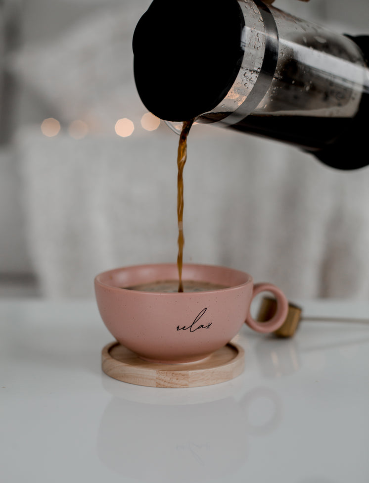 French Press Pours Coffee Into A Pink Coffee Mug