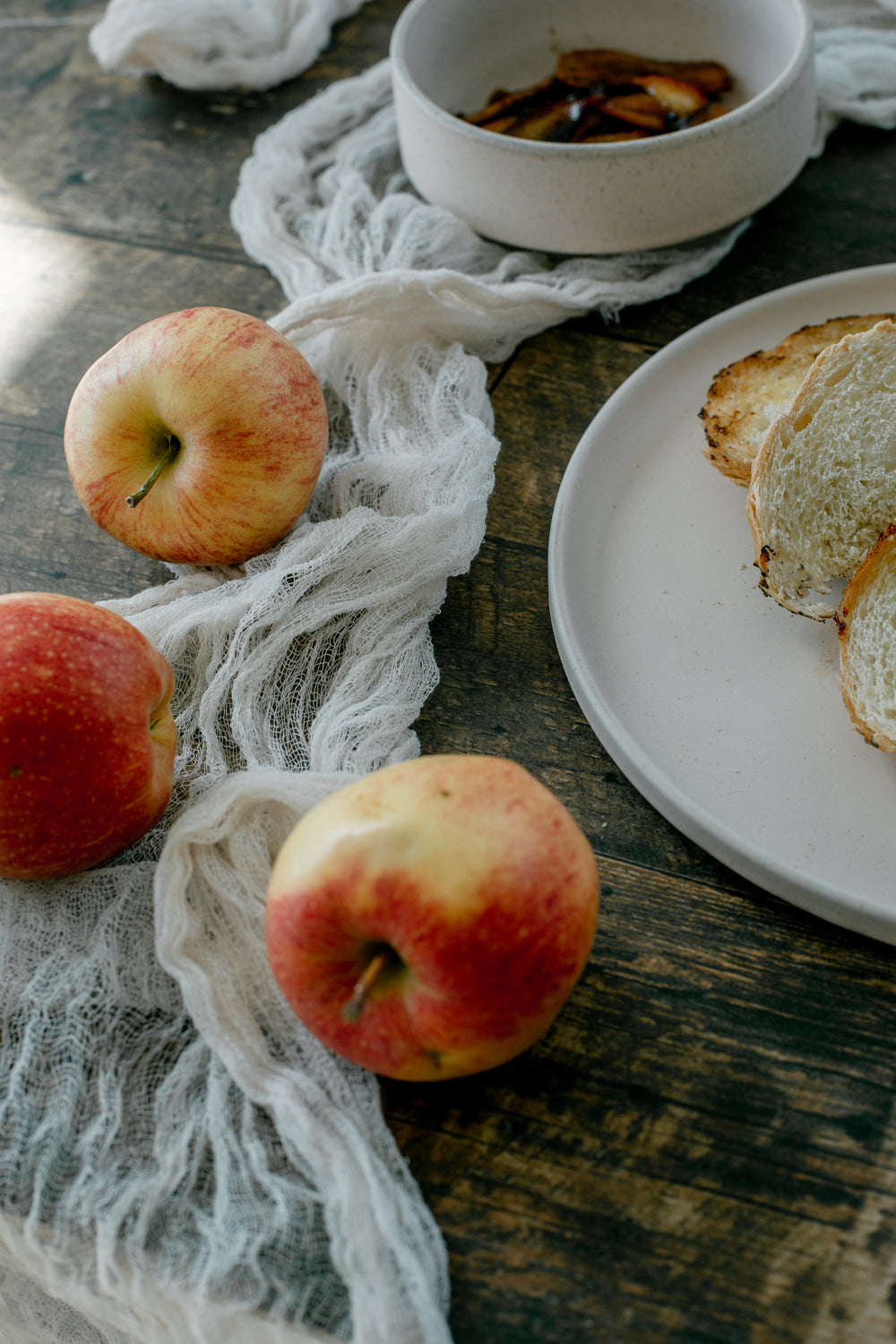 fresh bread and apples on rustic table