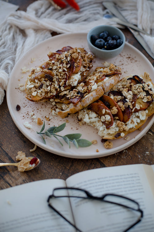 fresh bread covered in fruit with a book