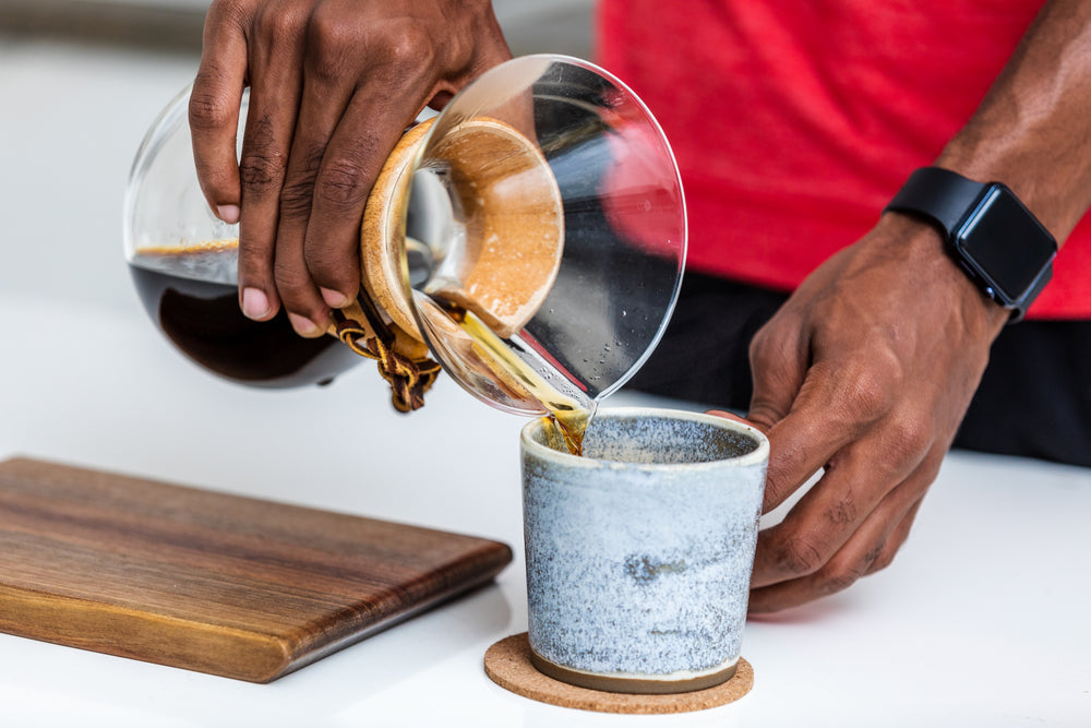 fresh cup of black coffee being poured