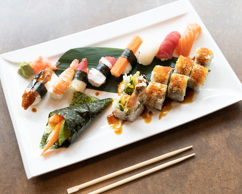 fresh sushi rolls on white plate