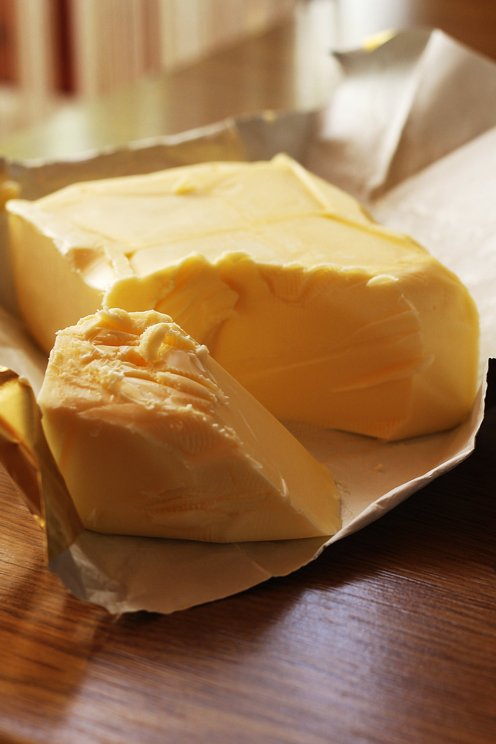 fresh unwrapped butter in a sunny kitchen