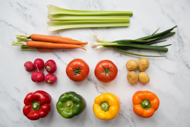 fresh vegetables arranged on chopping board flatlay