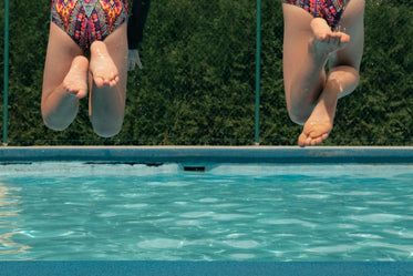 friends jump in pool together