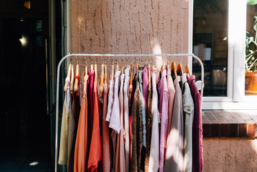 full metal clothing rack sits outside a shops entrance