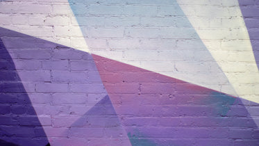 geometric purple urban art on brick wall