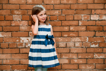 girl by brick wall