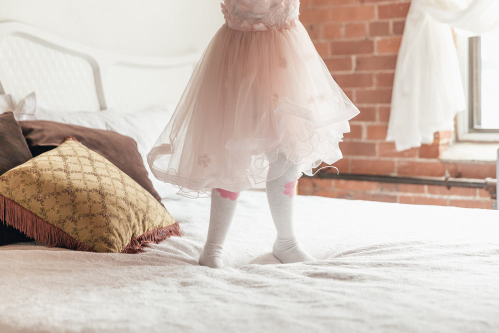 girl in dress on bed