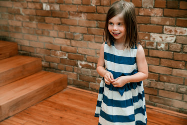 girl in dress smiles