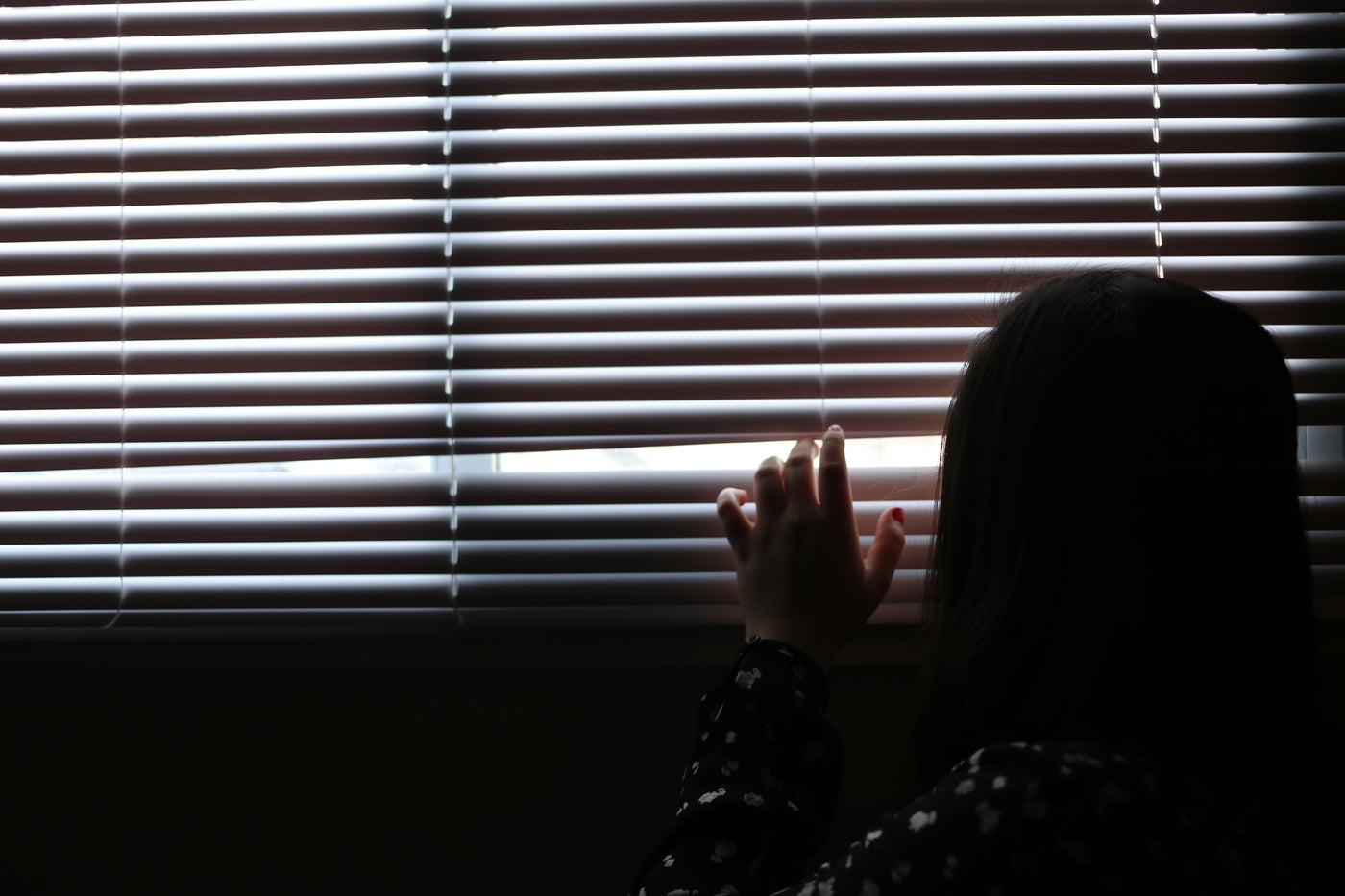 A young woman looking out through a window