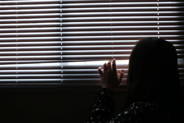 girl peaking outside window