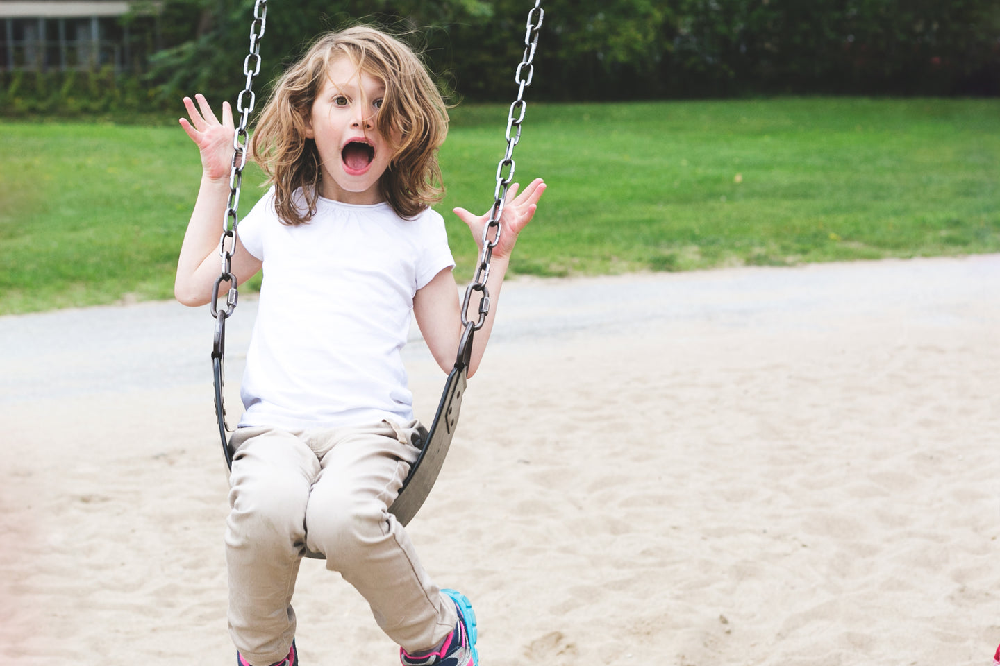 Girl Playing On Park Swings