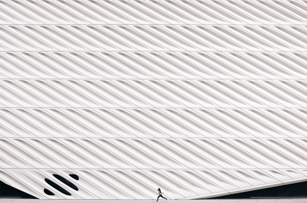 girl running past modern architecture