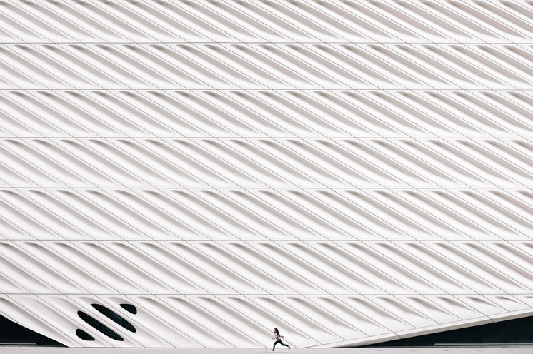 Girl Running Past Modern Architecture