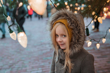 girl under holiday lights