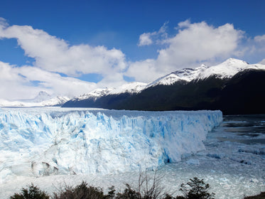 glacier edge below jagged mountains