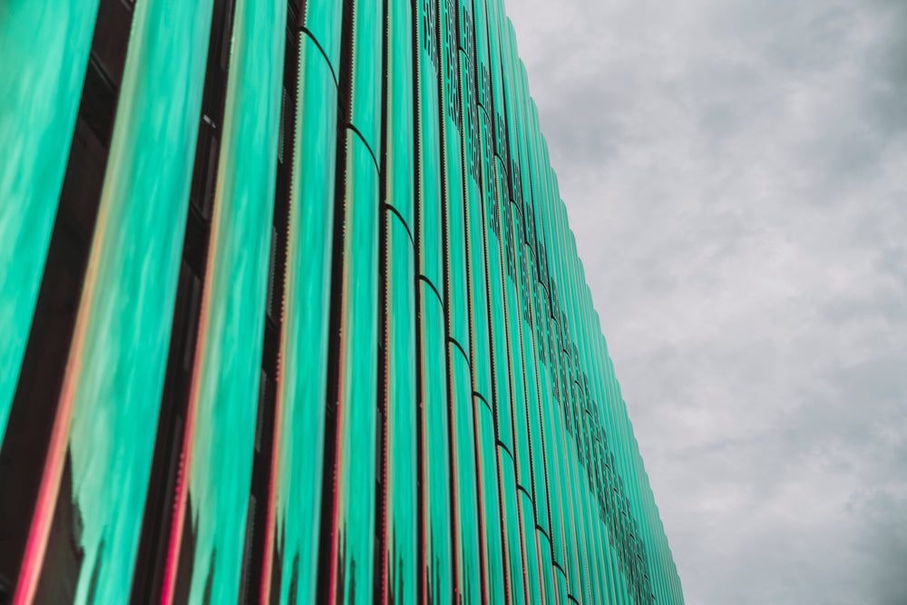 glass building reflects blue