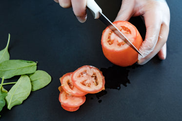 gloved hands preparing vegetables