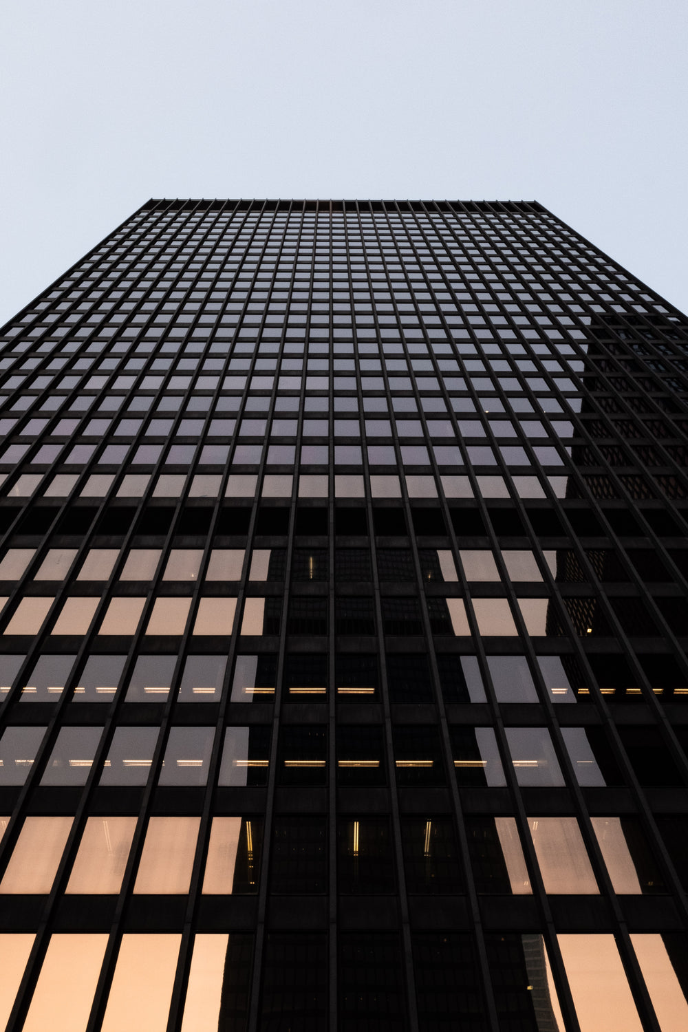 glowing reflection on building under dusk sky