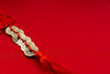 gold coins weaved onto red rope