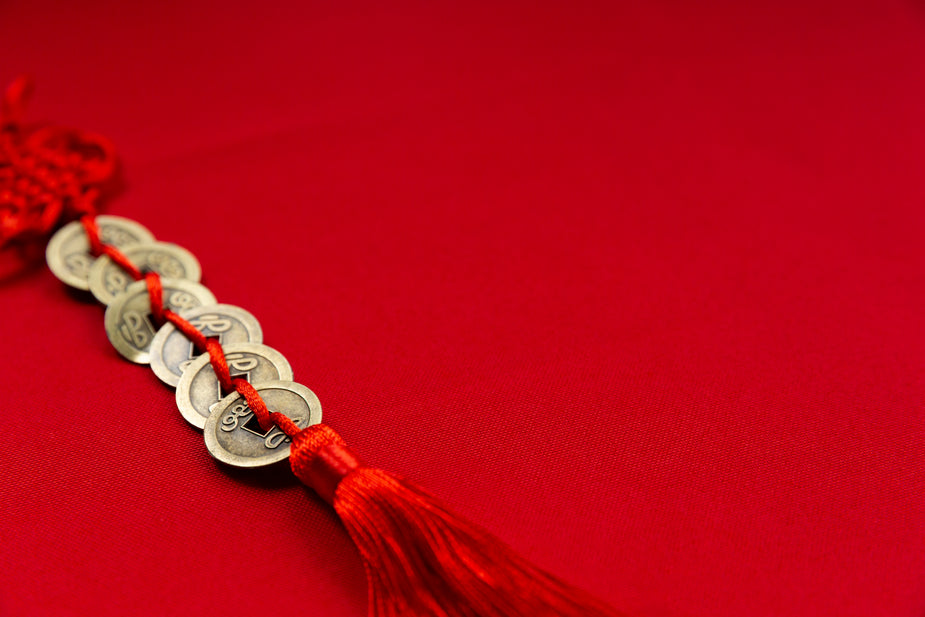 Browse Free HD Images of Gold Coins Weaved Onto Red Rope