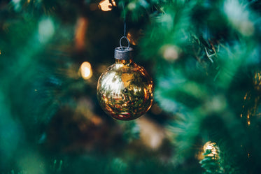 gold metallic ball ornament on tree