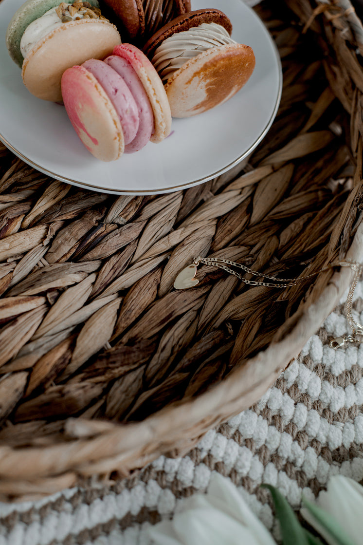 Gold Necklace Next To Colorful Macarons