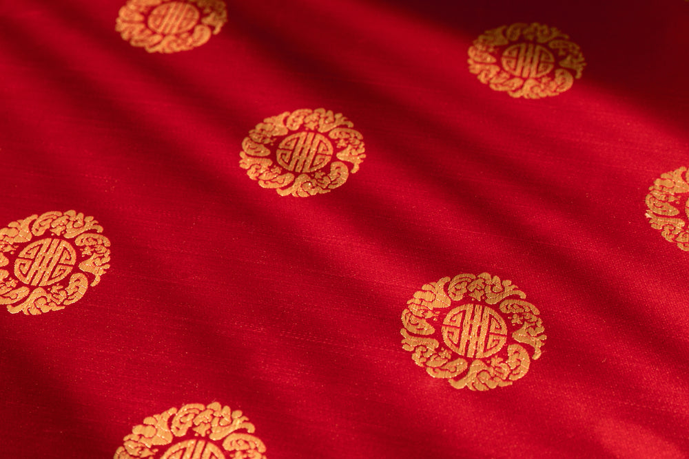 gold pattern on red brocade fabric