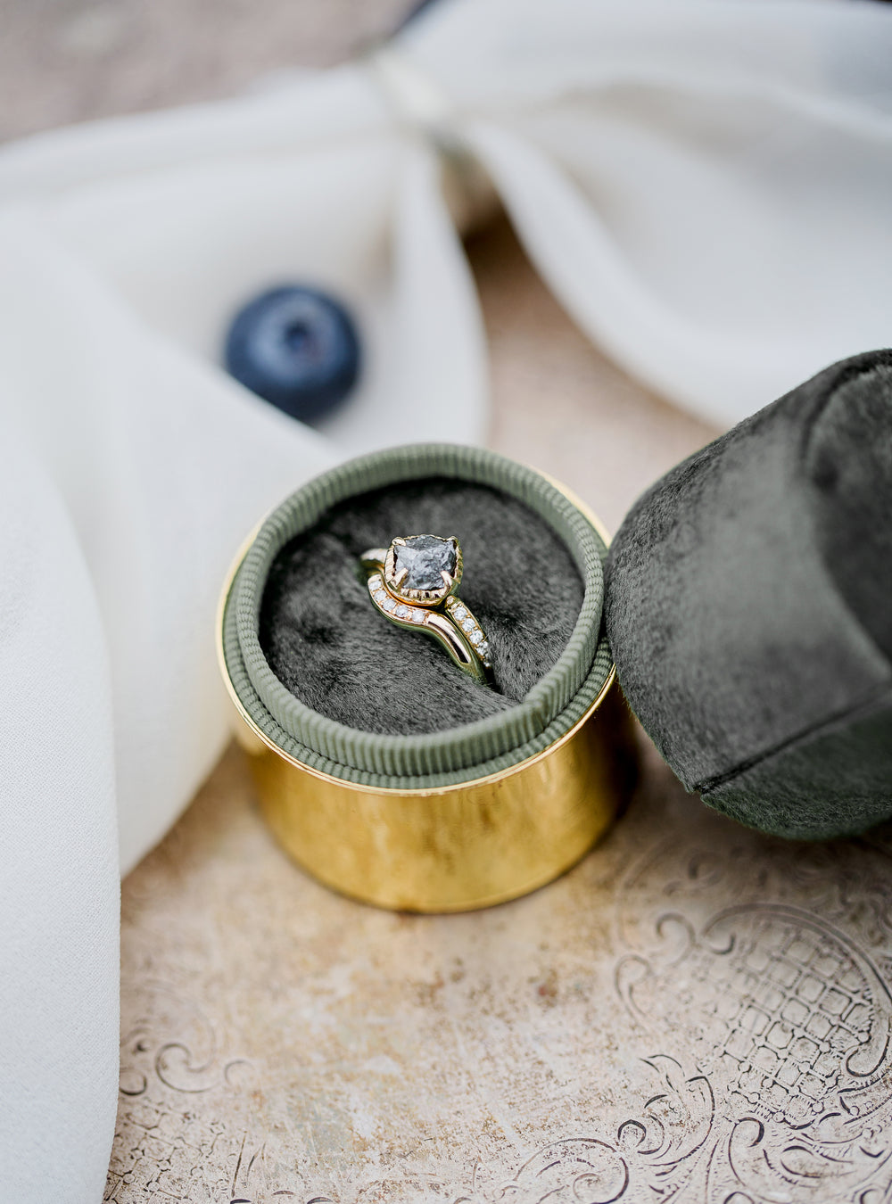 gold ring with white dimonds and a large stone