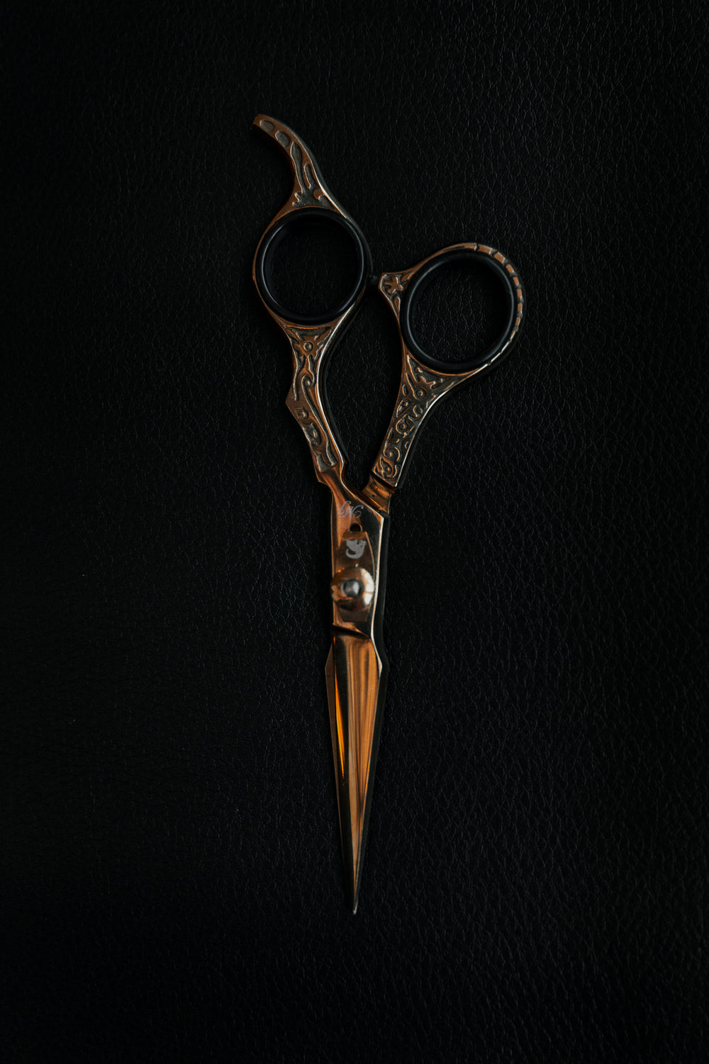 gold scissors against black