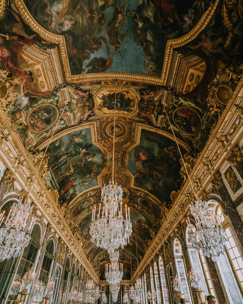 gold-trimmed frescoes and crystal chandeliers
