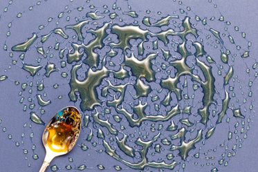 golden spoon and metallic liquid