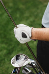 golfer holds club with gloves