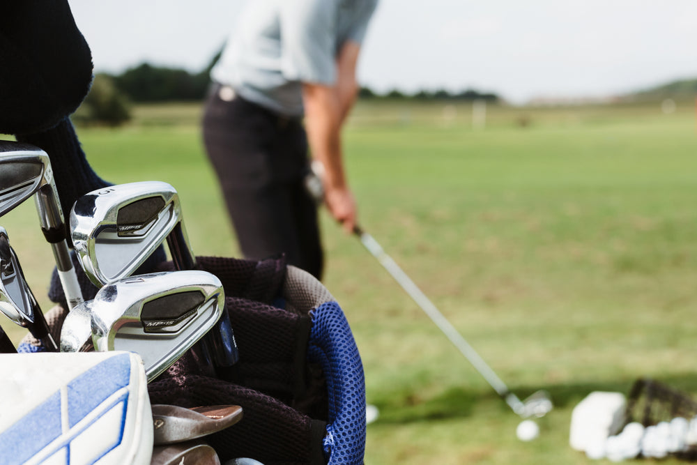 golfer lines up at driving range